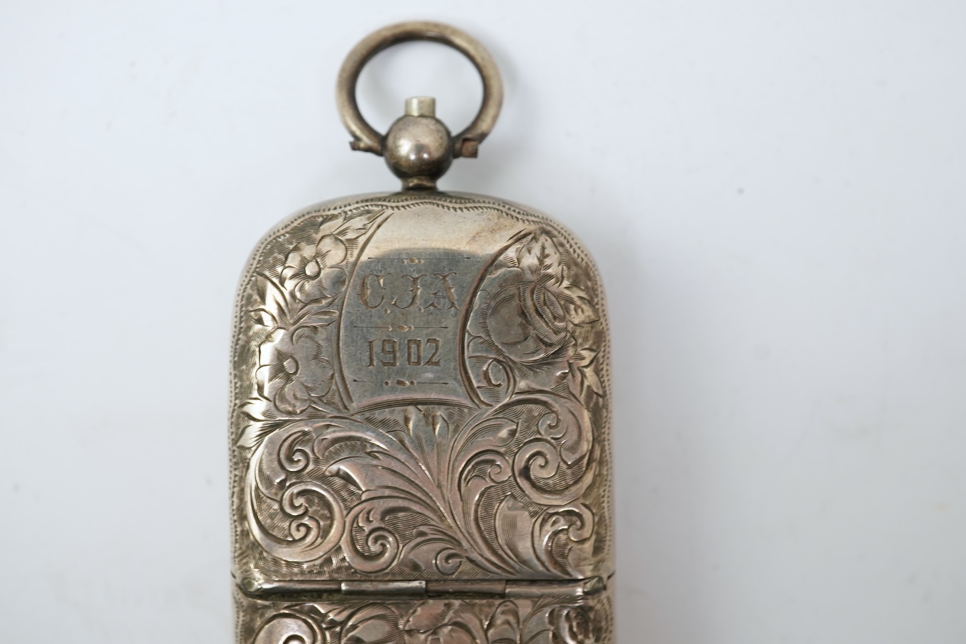 A late Victorian engraved silver oval combination sovereign and vesta case, by JW